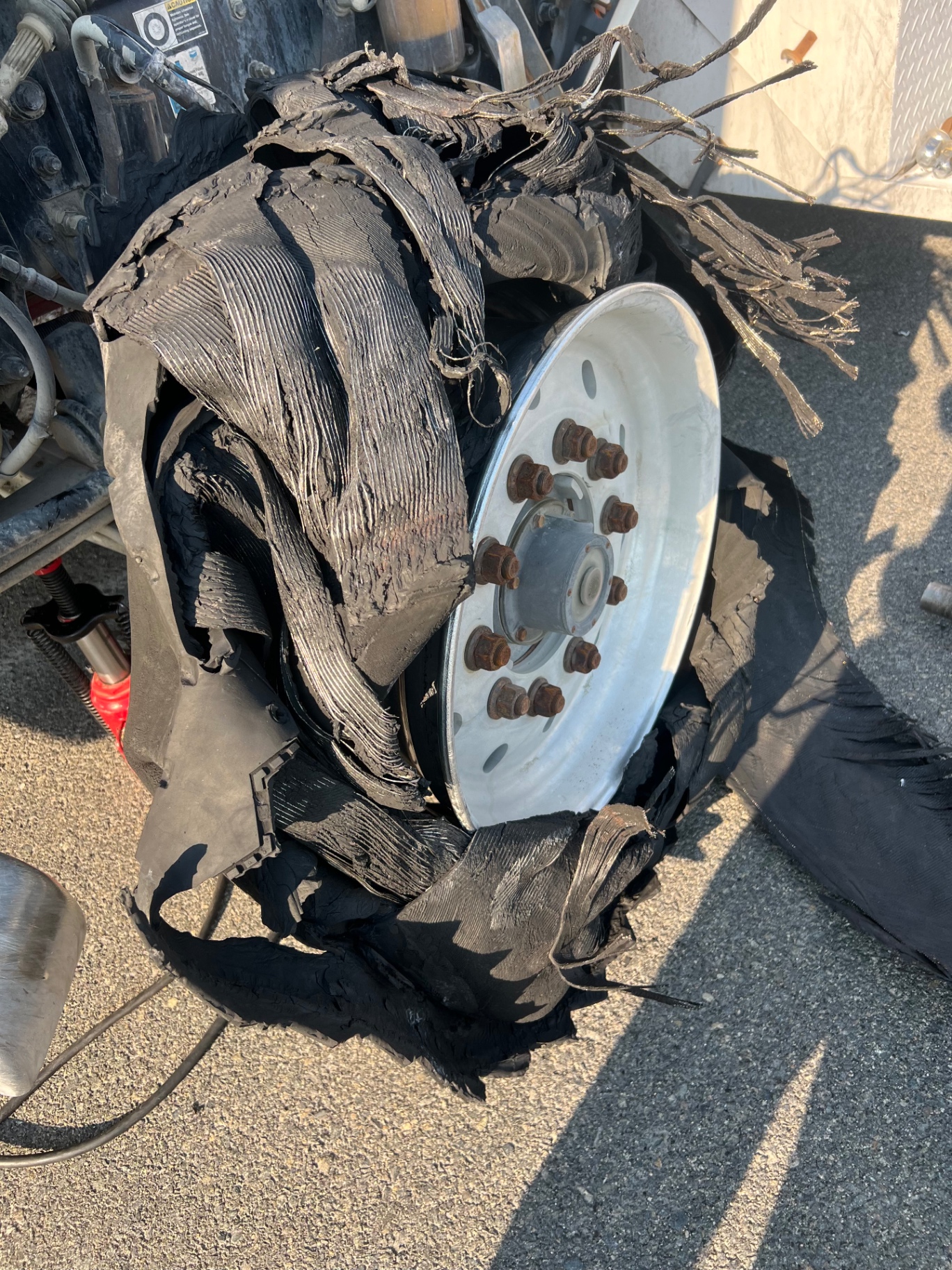 Destroyed commercial truck tire replaced on the road