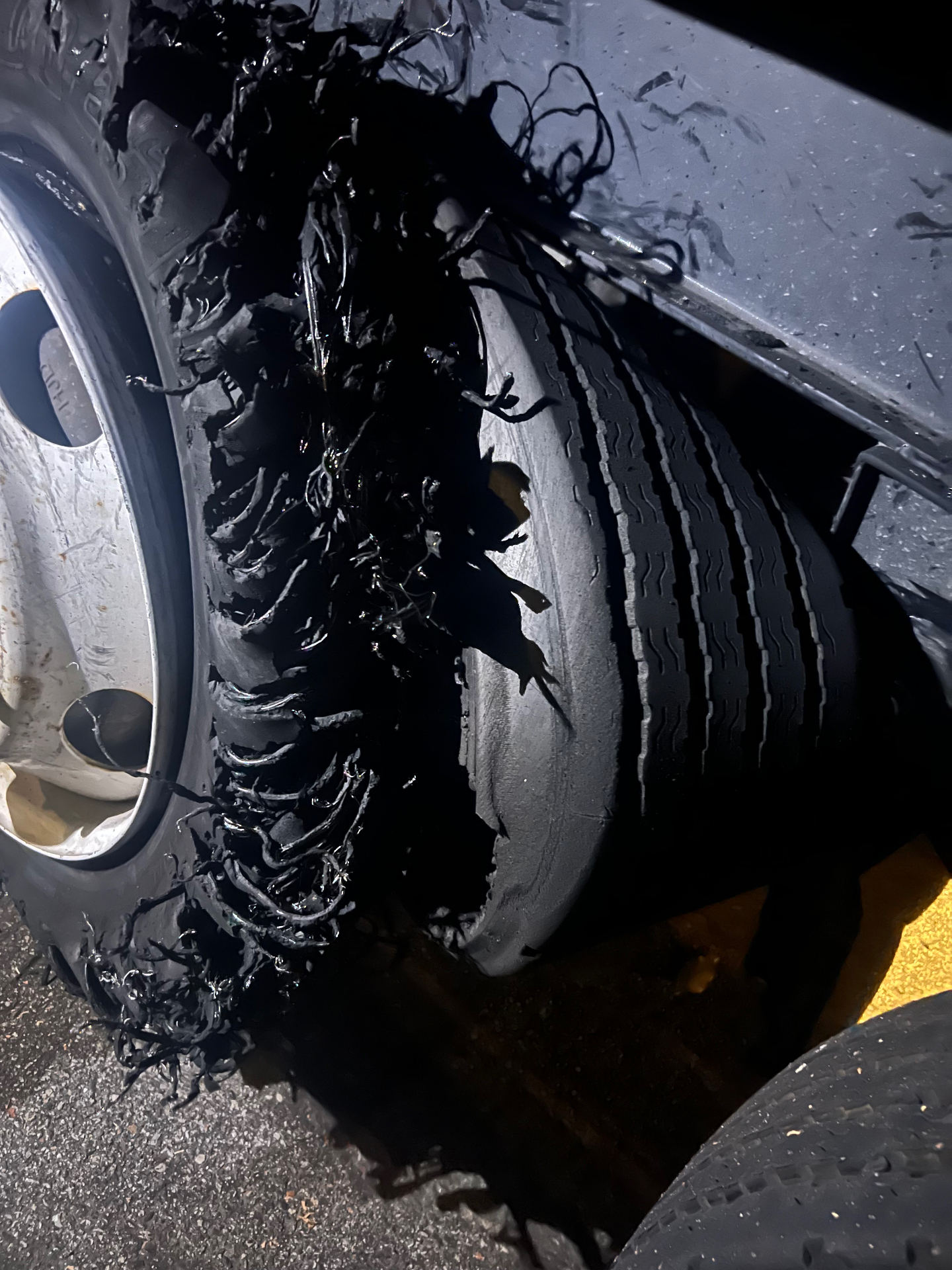 Night roadside semi truck tire blowout serviced by F&K Tires LLC